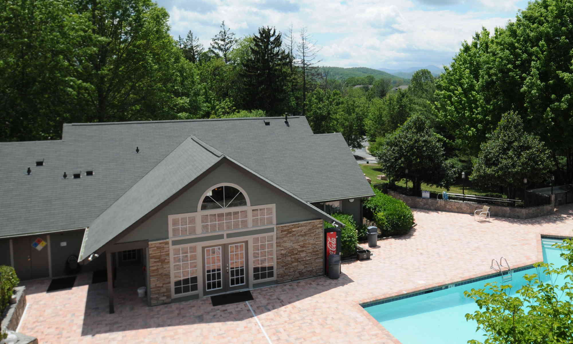 The Views at Asheville. Exterior view of the rear of the leasing office. Pool partially visible in foreground.