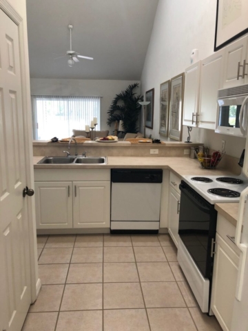 Kitchen in two bedroom flat. View from garage entry door looking into apartment.